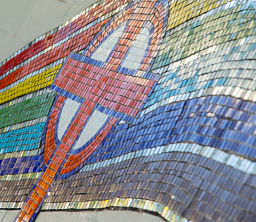 Image of mosaic icon from the school courtyard showing a Rainbow representing our Covenant Guiding Lights and a cross