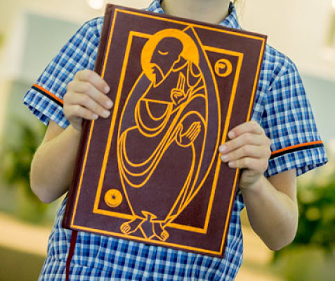 Image of a student holding the bible