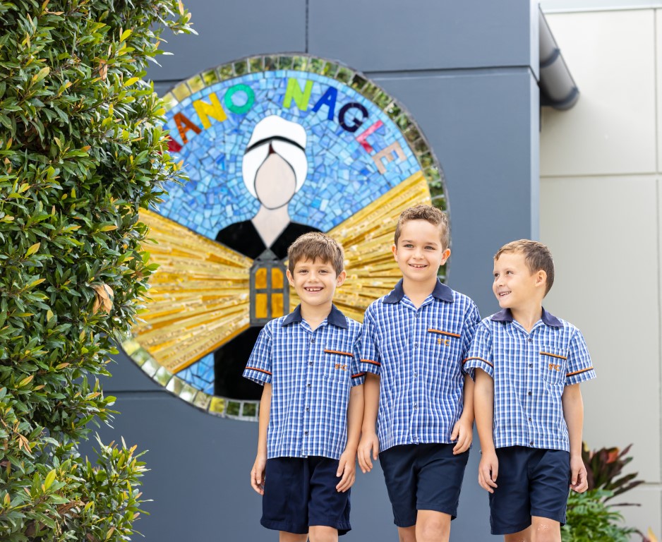 Students in school uniform in front of a “Nano Nagle” mosaic.