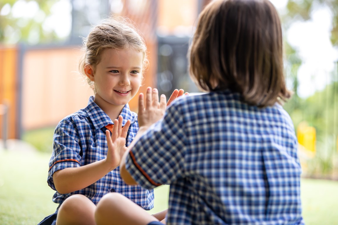 Two students playing outside.