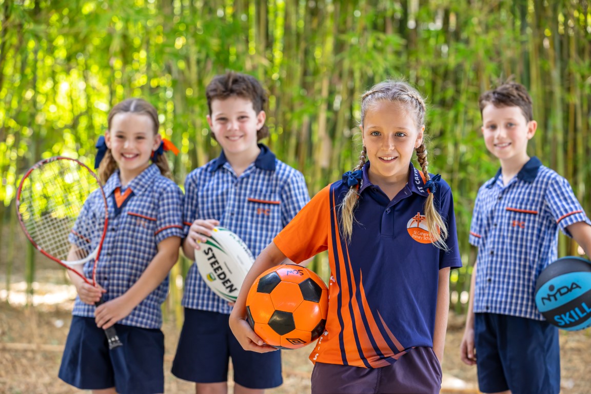 Students holding a variety of sports equipment