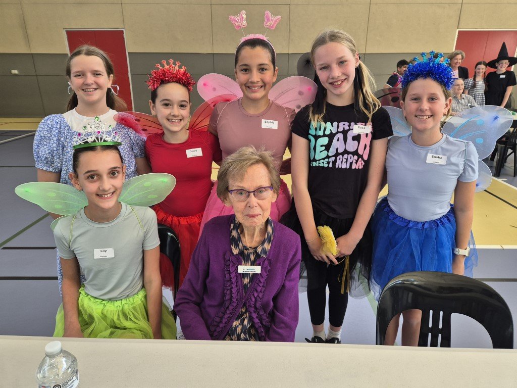 Image of Year 6 students surrounding a senior guest